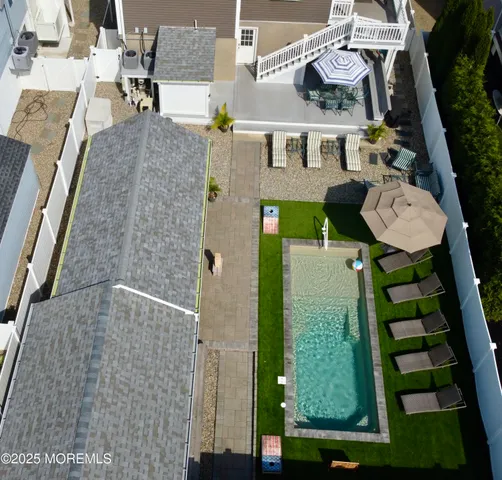 an aerial view of residential houses with outdoor space
