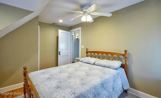 a bedroom with a large bed and a tv