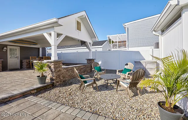 a view of a dining room with furniture and a chandelier