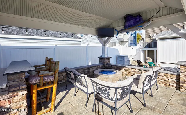 a living room with couches chairs and kitchen view