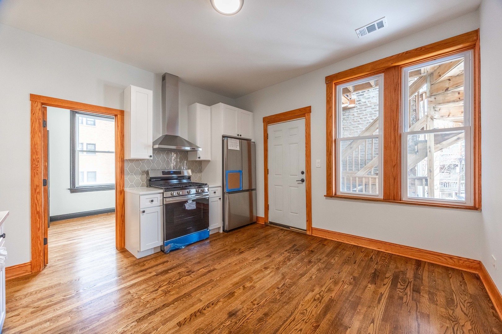 2842 West Augusta Boulevard, Unit 2E Chicago, IL 60622 - Photo 12 of 23 a kitchen with stainless steel appliances granite countertop a refrigerator and a stove top oven