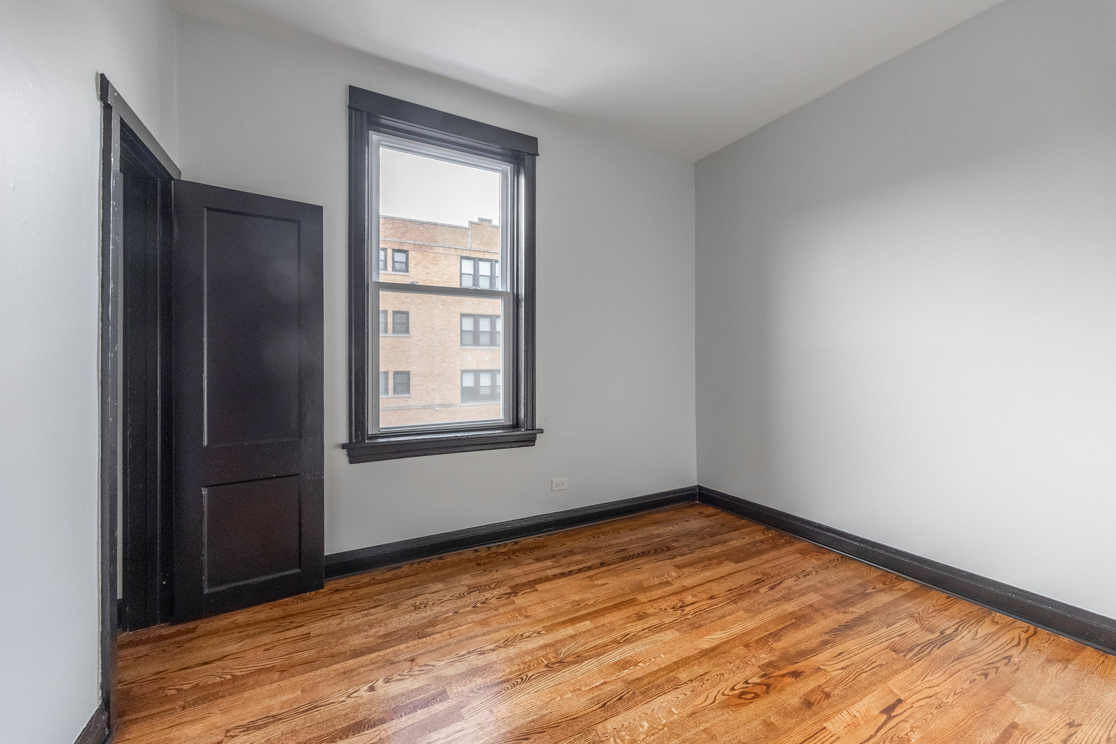 2842 West Augusta Boulevard, Unit 2E Chicago, IL 60622 - Photo 19 of 23 a view of empty room with wooden floor and fan