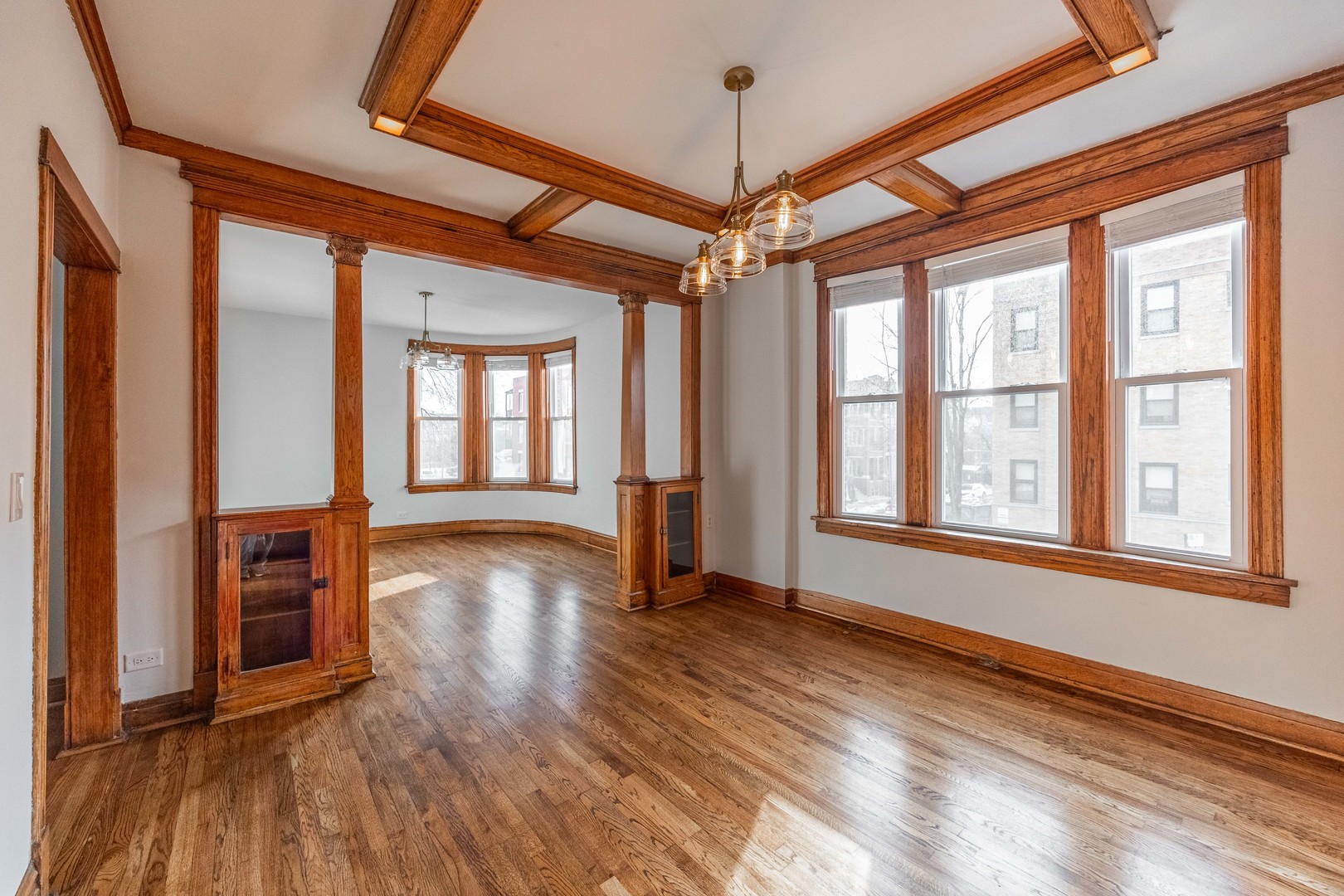 2842 West Augusta Boulevard, Unit 2E Chicago, IL 60622 - Photo 2 of 23 a view of an empty room with wooden floor and a window