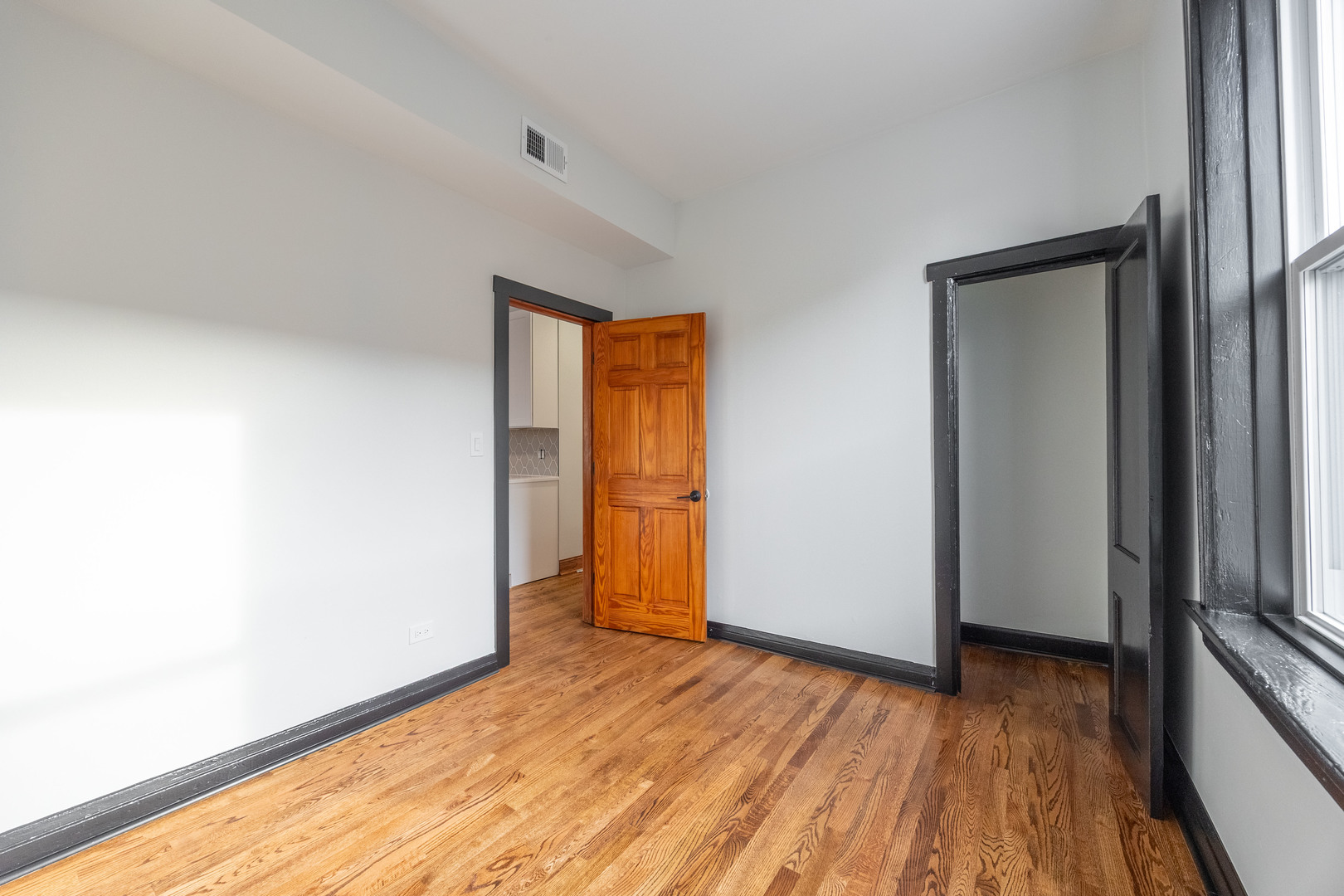 2842 West Augusta Boulevard, Unit 2E Chicago, IL 60622 - Photo 21 of 23 a view of empty room with wooden floor and fan