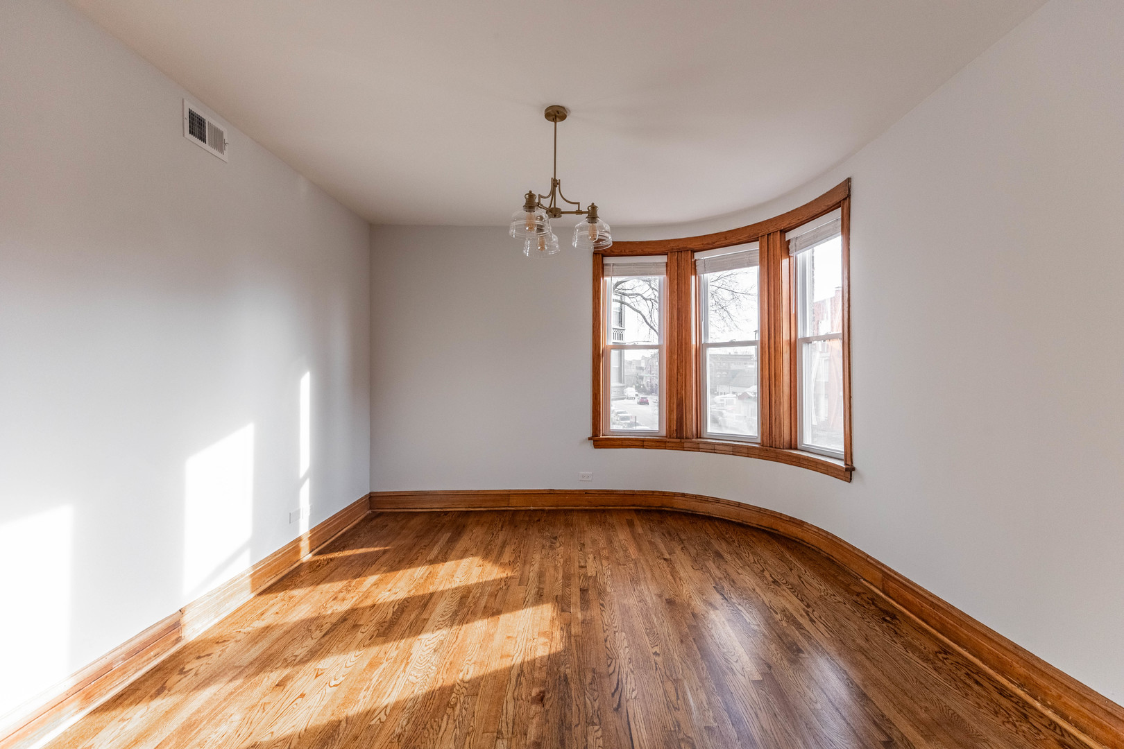 2842 West Augusta Boulevard, Unit 2E Chicago, IL 60622 - Photo 4 of 23 a view of empty room with wooden floor and fan