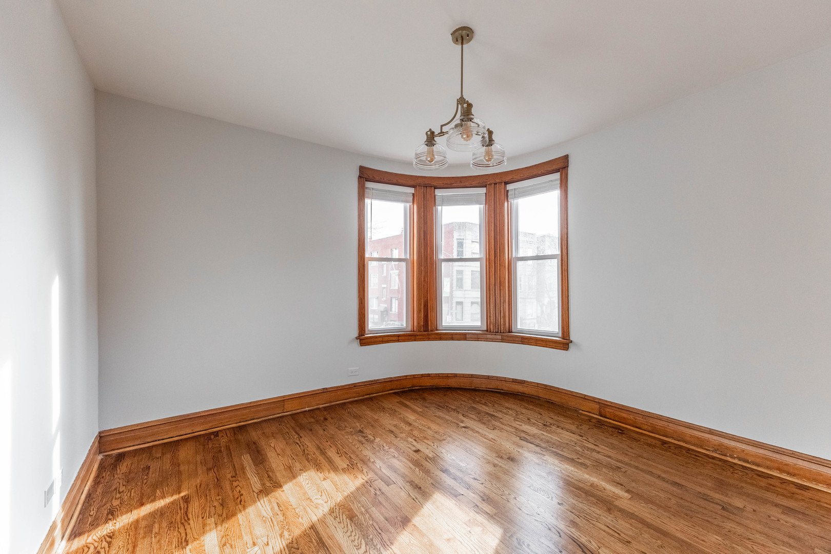2842 West Augusta Boulevard, Unit 2E Chicago, IL 60622 - Photo 5 of 23 a view of empty room with wooden floor and fan