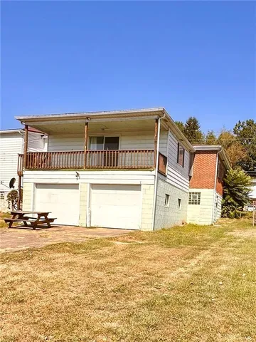 a front view of a building with a ocean view