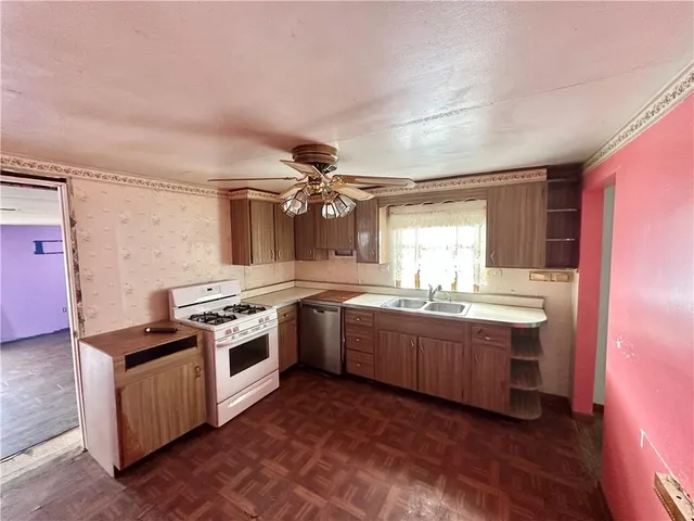 a kitchen with sink stove and cabinets