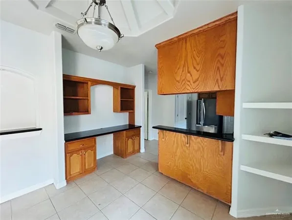 a kitchen with stainless steel appliances a refrigerator and a microwave
