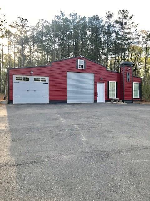 2157 Monroe Mill Road Buchanan, GA 30113 - Photo 1 of 1 a view of a large building with a big yard and large trees