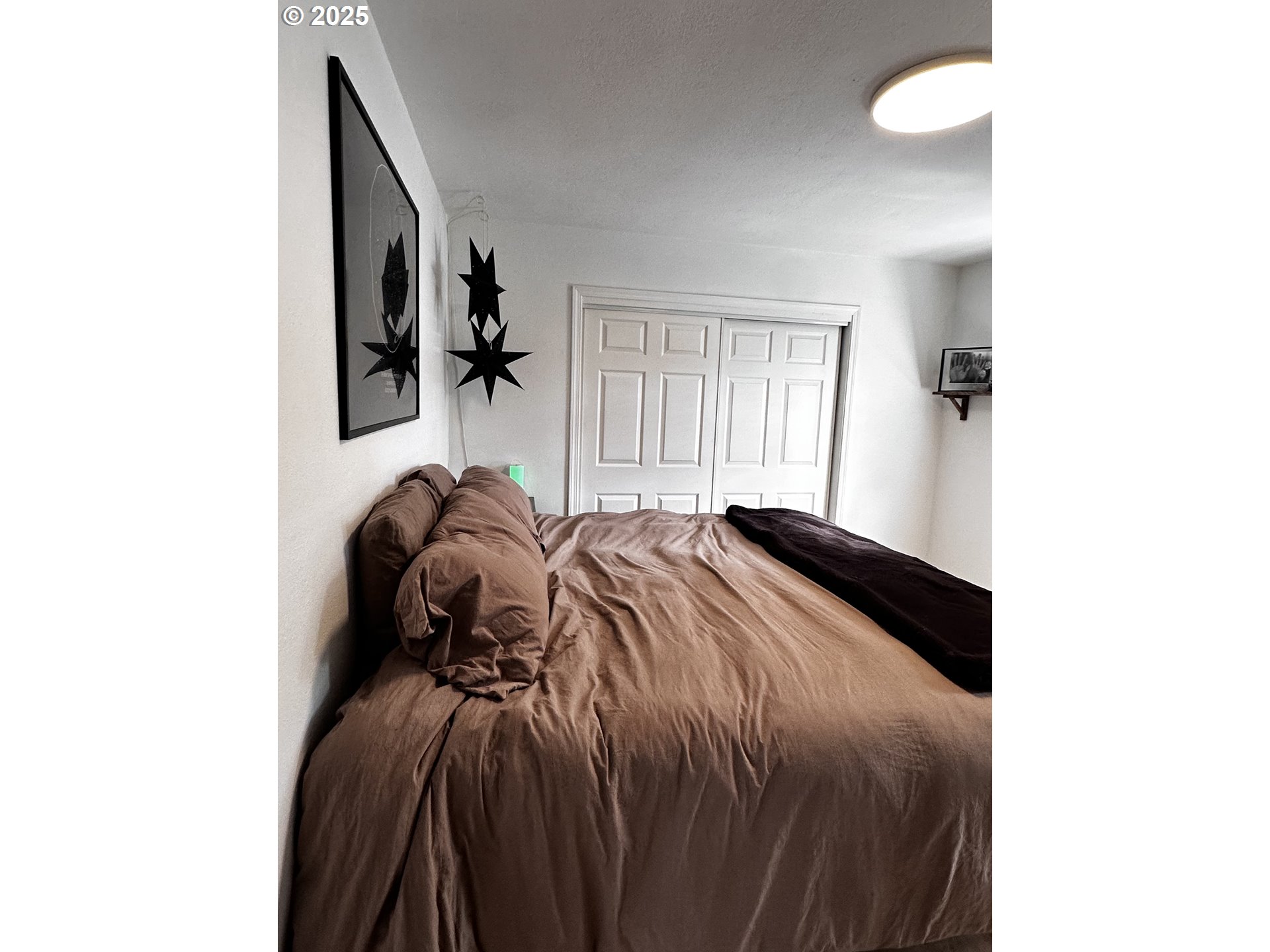 2136 Greenwood Avenue Reedsport, OR 97467 - Photo 20 of 20 a bed room with a bed and a painting