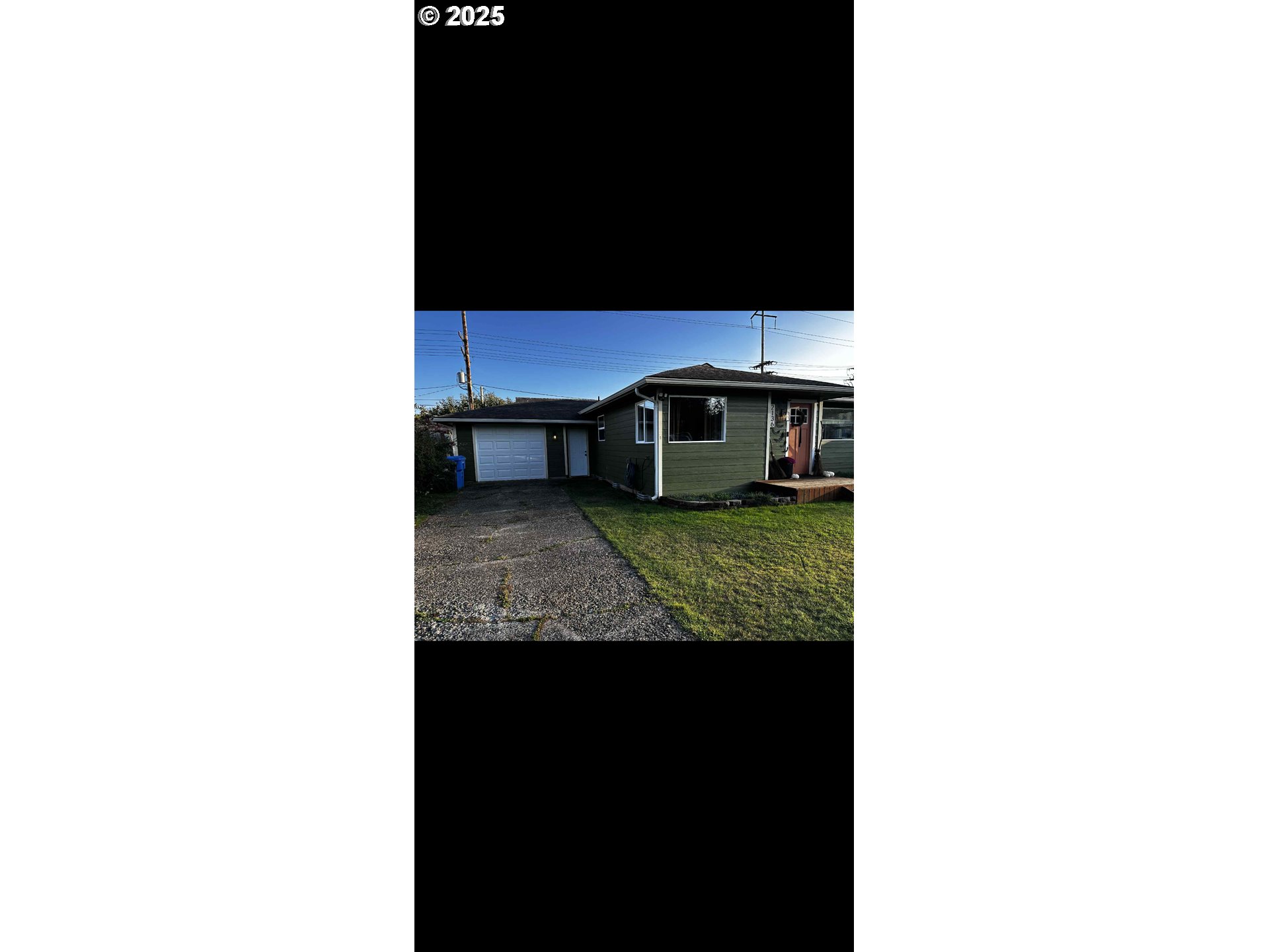 2136 Greenwood Avenue Reedsport, OR 97467 - Photo 2 of 20 a living room with a rug and a clock