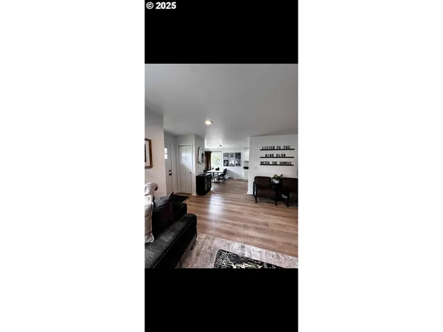 a view of a living room with furniture and a fireplace