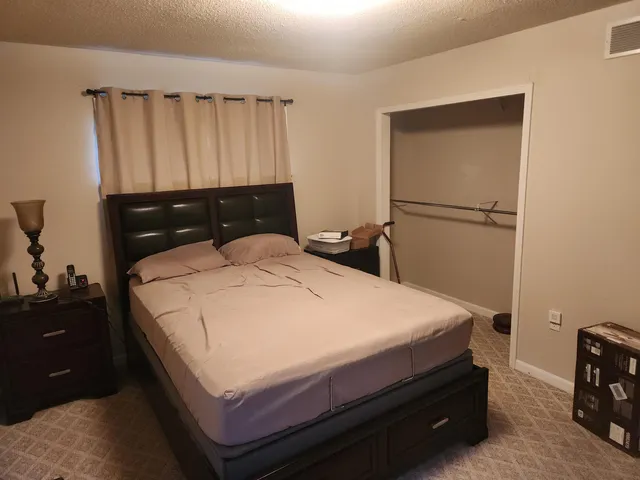a bedroom with a bed and a dresser
