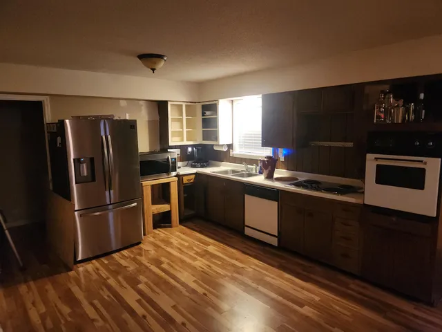 a kitchen with stainless steel appliances a refrigerator stove and microwave