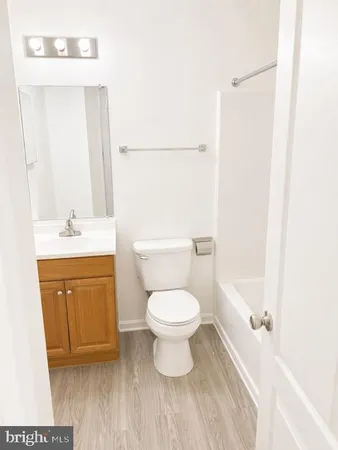 a bathroom with a toilet sink and a mirror