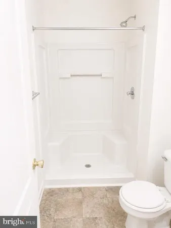 a bathroom with a shower and a toilet
