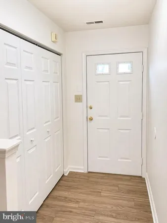 an empty room with wooden floor