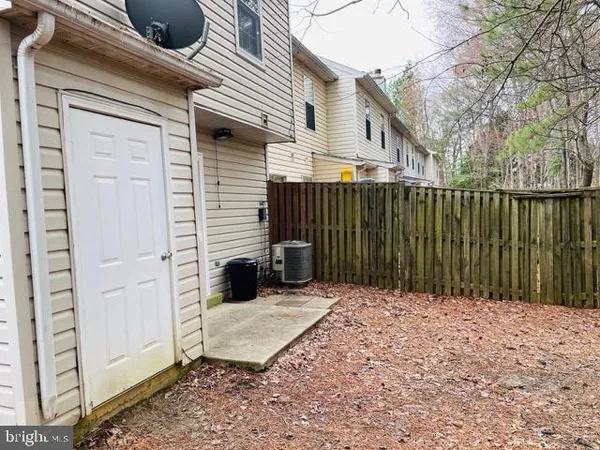 a view of backyard with wooden fence