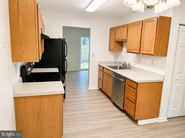 a kitchen with a sink and a refrigerator
