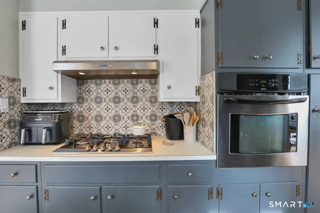 a kitchen with a stove and cabinets