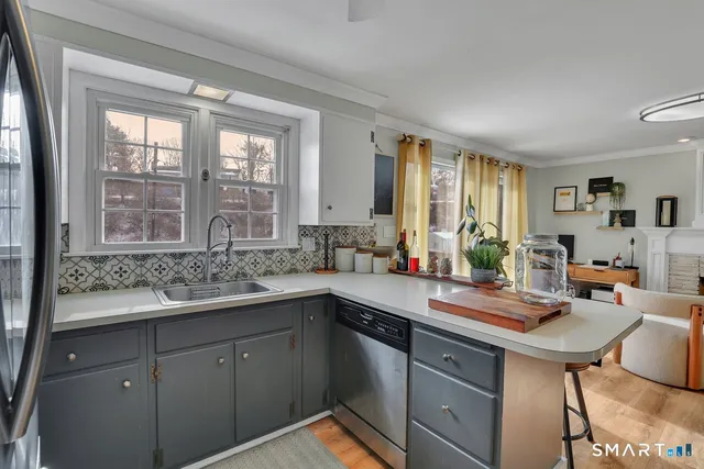 a kitchen with a sink stove and cabinets