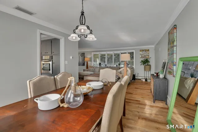 a living room with furniture chandelier and a window