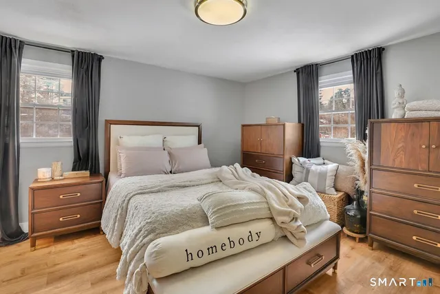 a bedroom with a bed and wooden floor