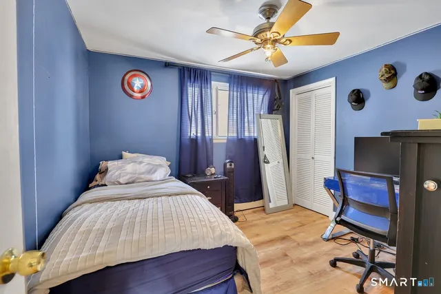 a bedroom with a bed and a chandelier