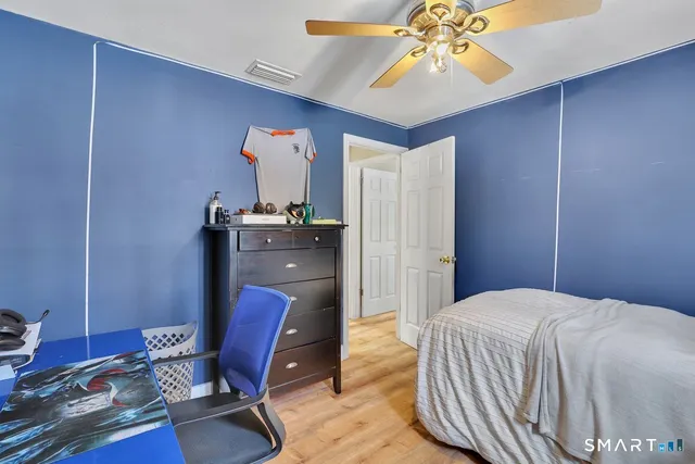 a bedroom with a bed and a chandelier