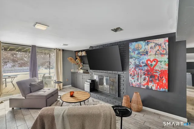 a living room with furniture a rug and a flat screen tv