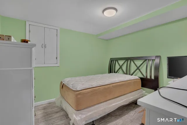 a bedroom with a bed and a tv