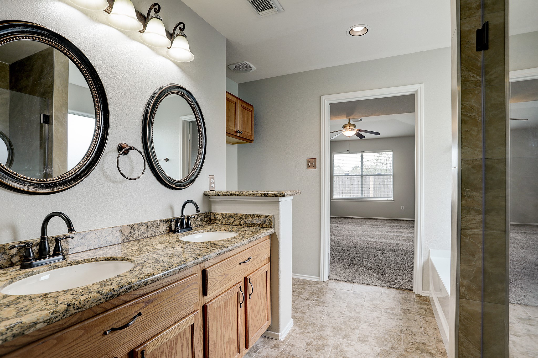 223 Sunset Colony Drive Rosharon, TX 77583 - Photo 18 of 45 Dual sinks with granite counters in the primary bathroom. Nice custom mirrors.