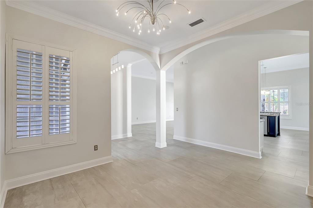 2863 Duncan Tree Circle Valrico, FL 33594 - Photo 12 of 53 an empty room with chandelier fan and windows