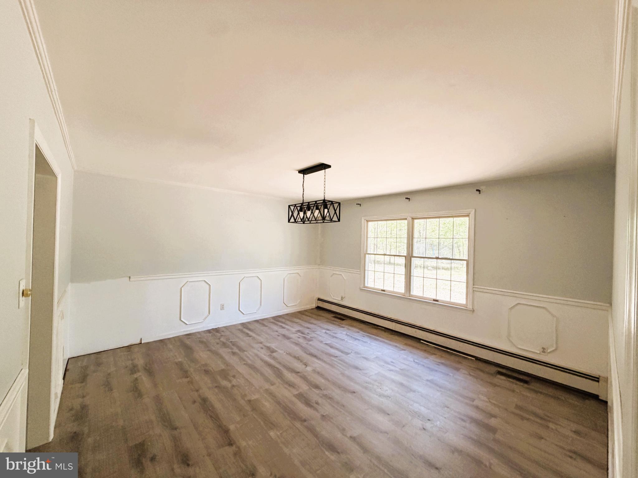 25865 Brookwood Road Greensboro, MD 21639 - Photo 12 of 18 wooden floor in an empty room with a window