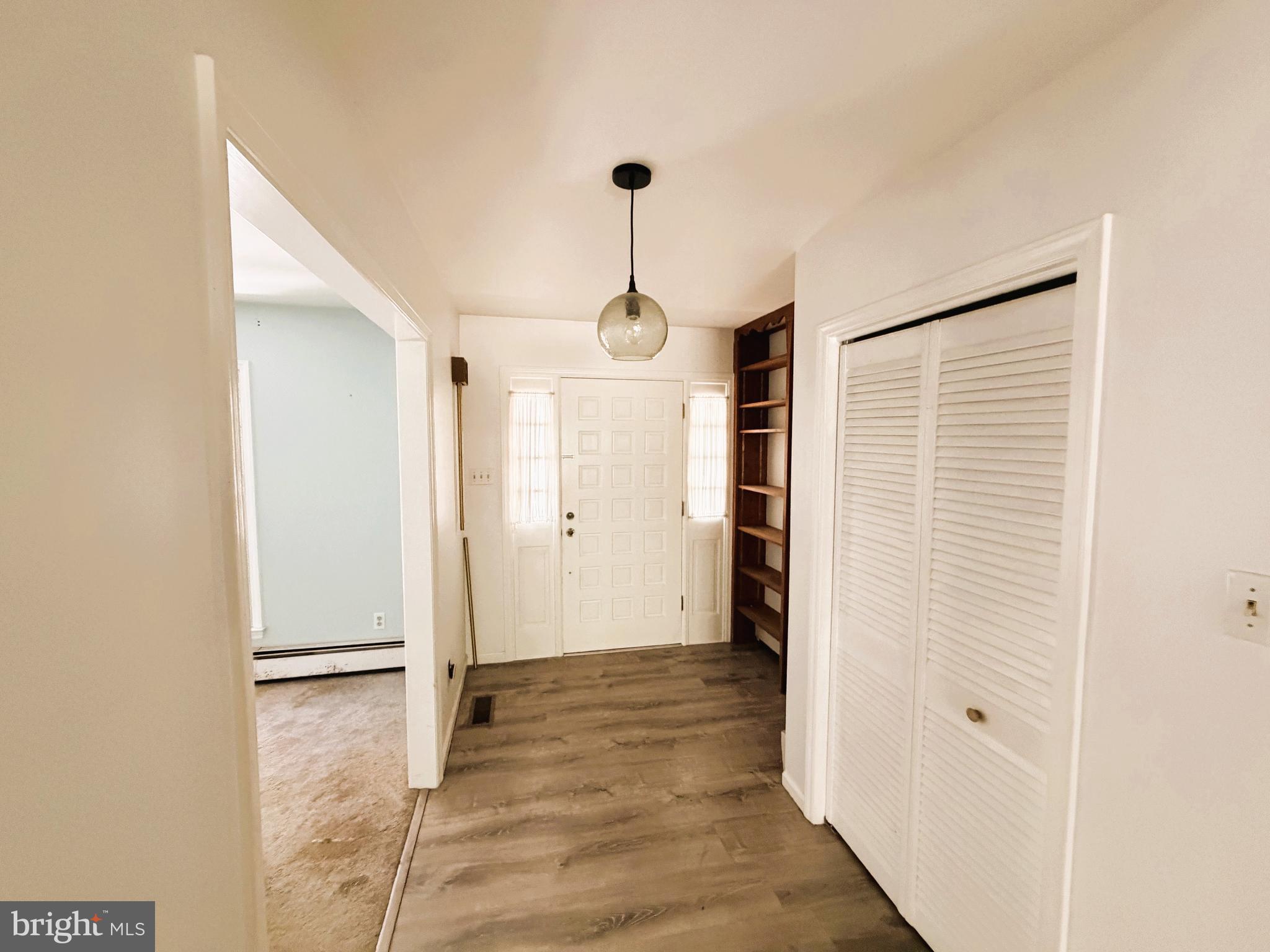 25865 Brookwood Road Greensboro, MD 21639 - Photo 13 of 18 a very nice looking hallway with a door and chandelier