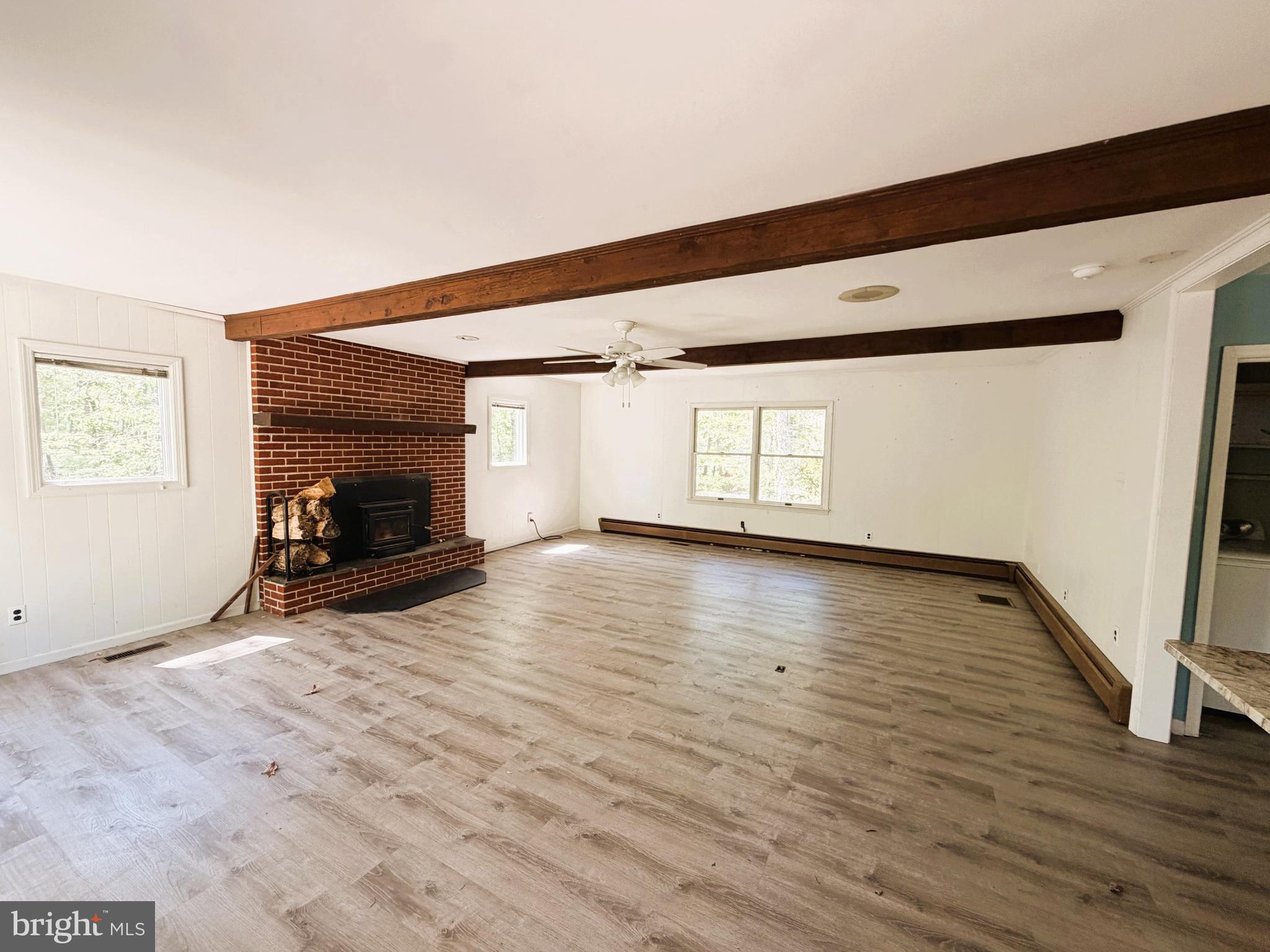 25865 Brookwood Road Greensboro, MD 21639 - Photo 9 of 18 a view of empty room with wooden floor and fan