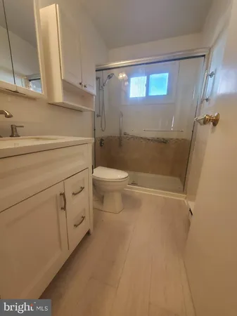 a bathroom with a toilet a sink and shower