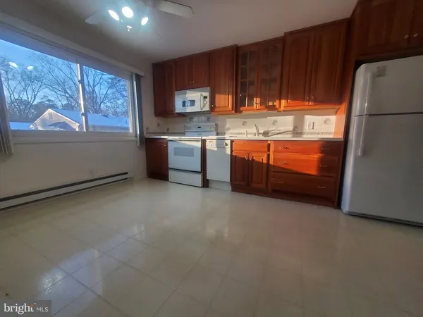 a kitchen with stainless steel appliances a refrigerator and a stove top oven