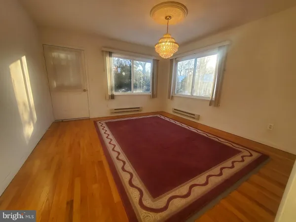 a view of a room with wooden floor and windows