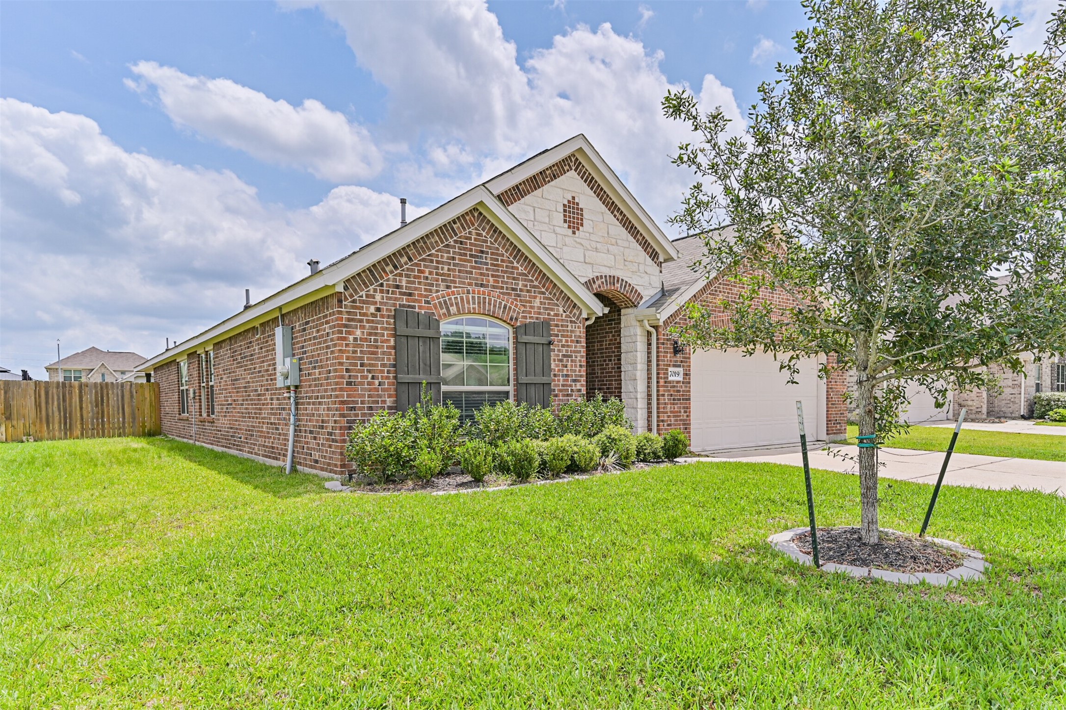 7019 Terra Drive Manvel, TX 77578 - Photo 3 of 41 a front view of a house with a yard and fence