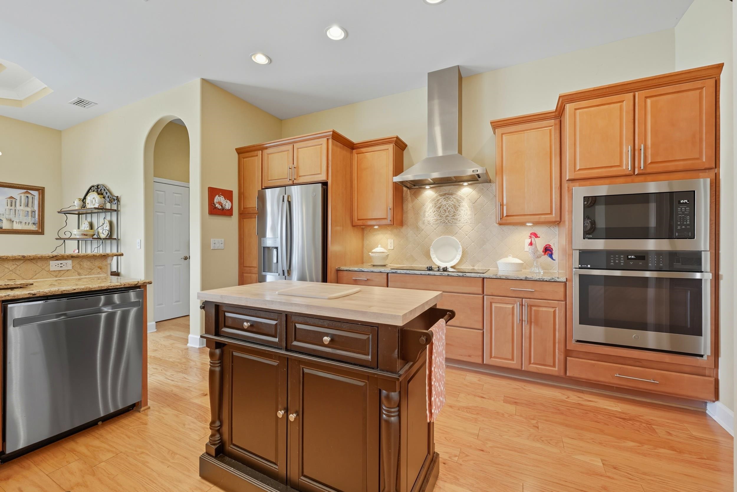 305 Marsh Point Circle St. Augustine, FL 32080 - Photo 13 of 82 a kitchen with stainless steel appliances granite countertop a stove a sink and a refrigerator