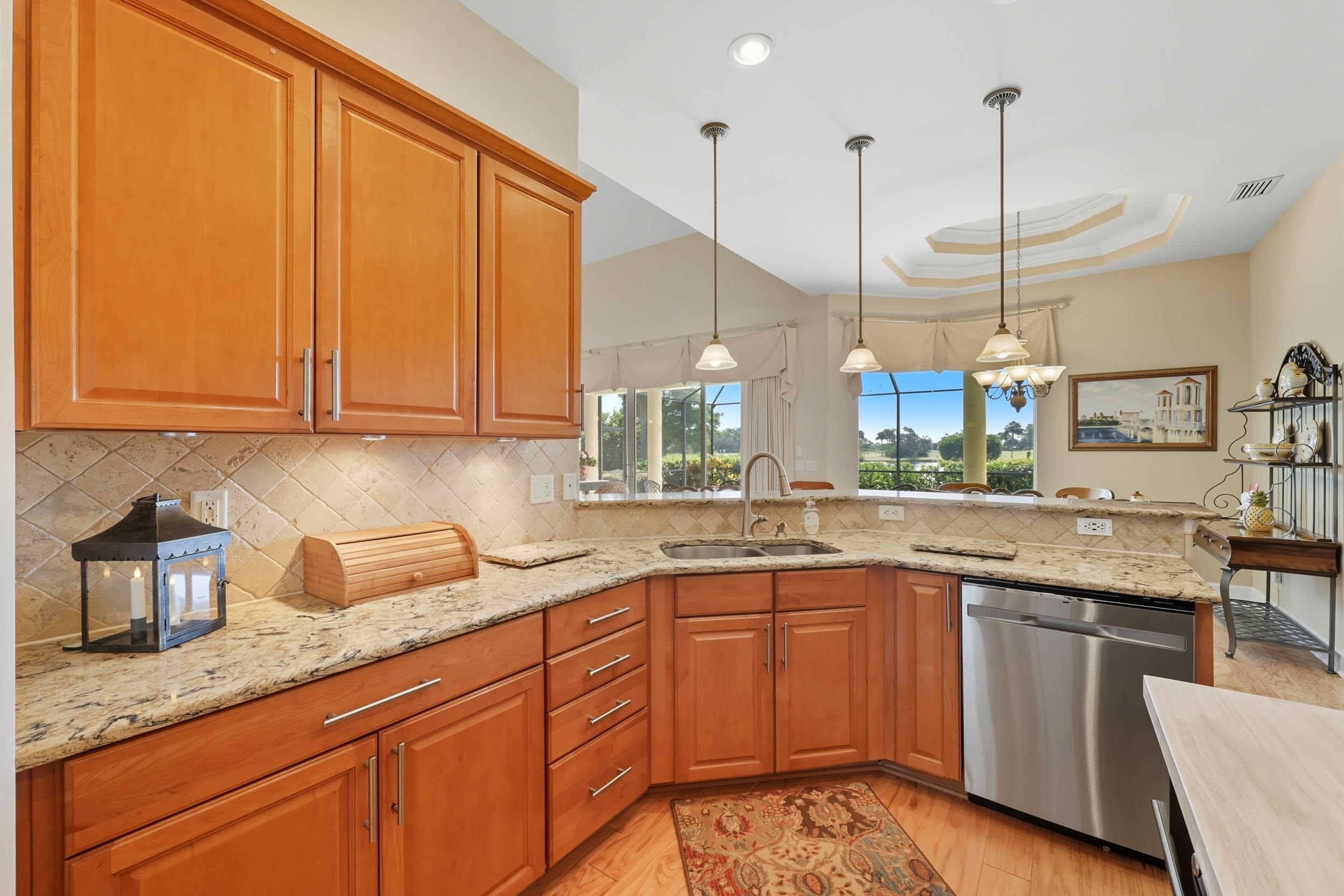 305 Marsh Point Circle St. Augustine, FL 32080 - Photo 14 of 82 a kitchen with stainless steel appliances granite countertop a sink a stove and a wooden floors