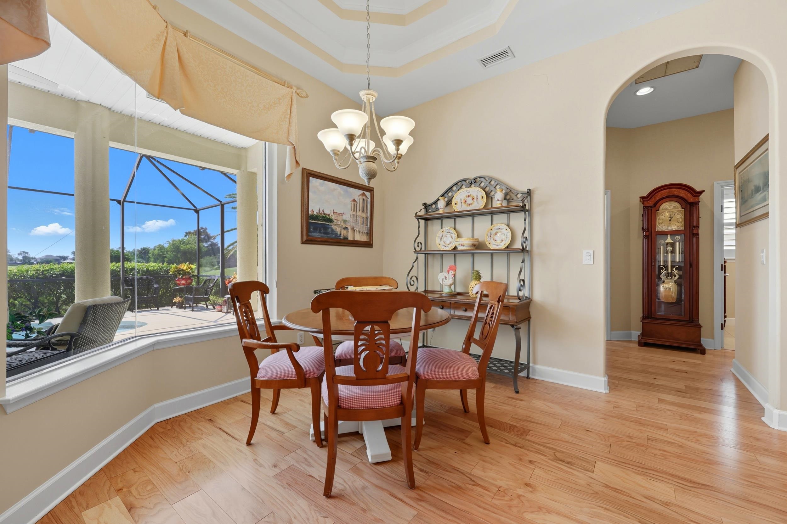 305 Marsh Point Circle St. Augustine, FL 32080 - Photo 19 of 82 a view of a dining room with furniture a chandelier and wooden floor
