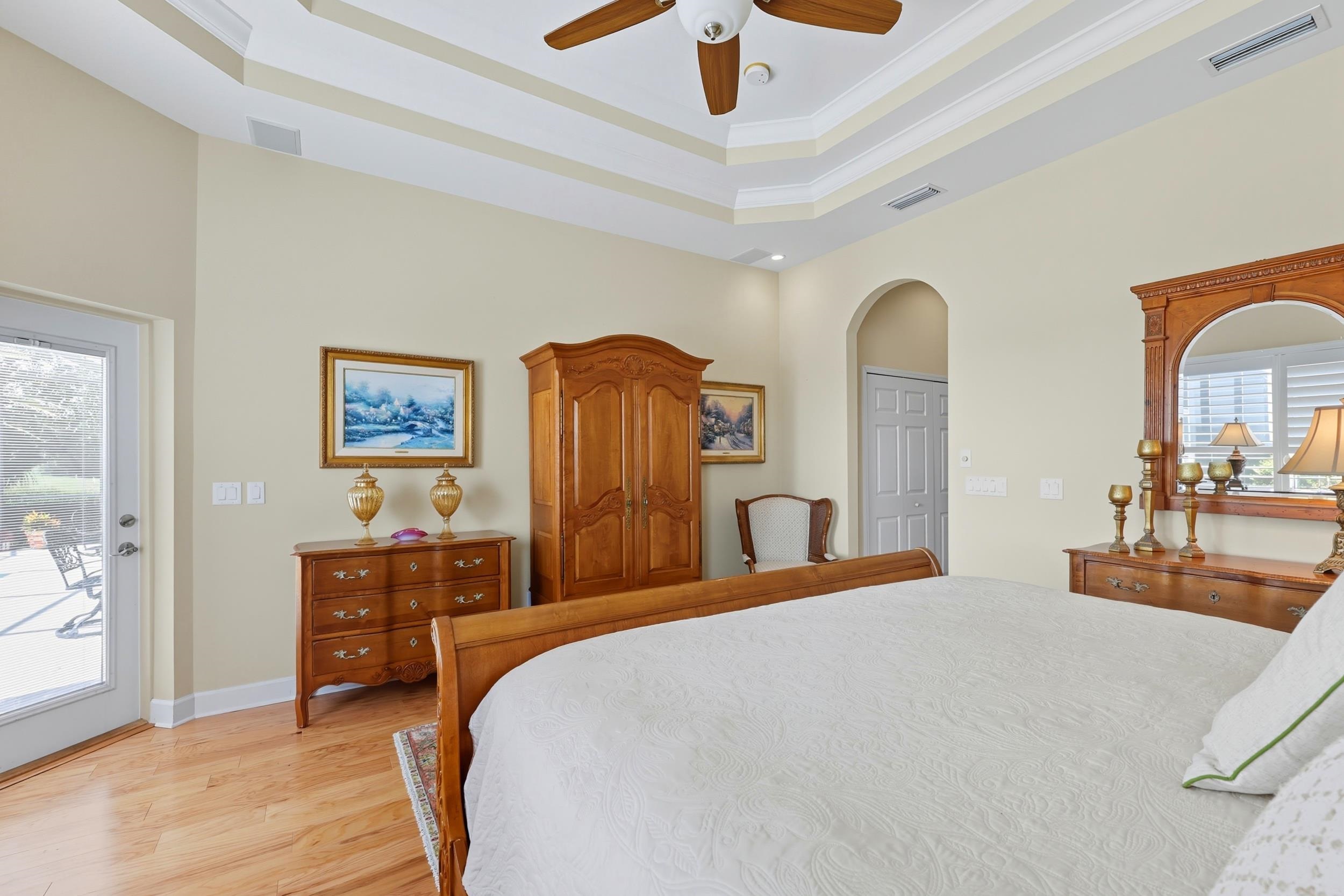 305 Marsh Point Circle St. Augustine, FL 32080 - Photo 25 of 82 a bedroom with a bed and a chandelier