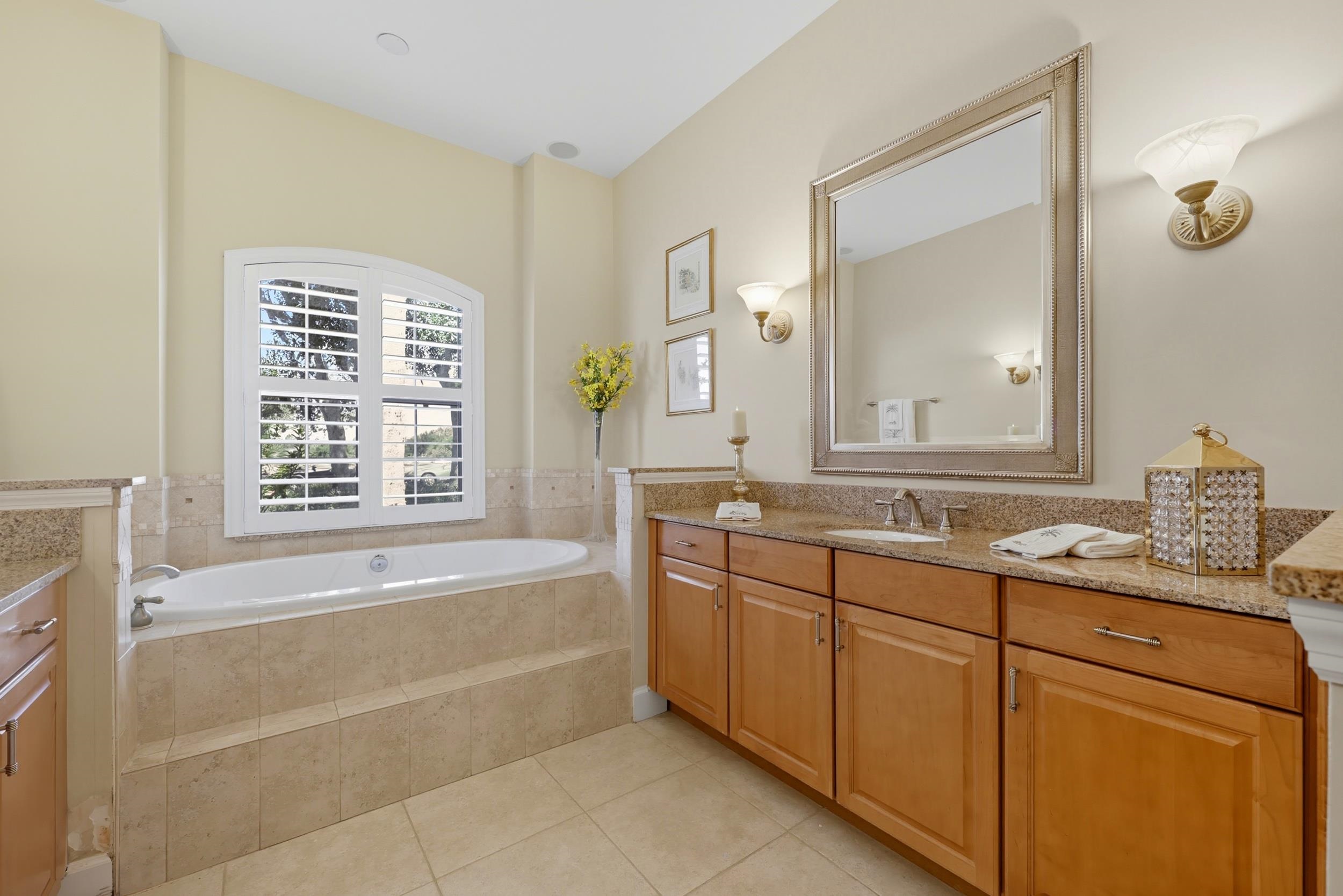305 Marsh Point Circle St. Augustine, FL 32080 - Photo 26 of 82 a bathroom with a tub sink and mirror