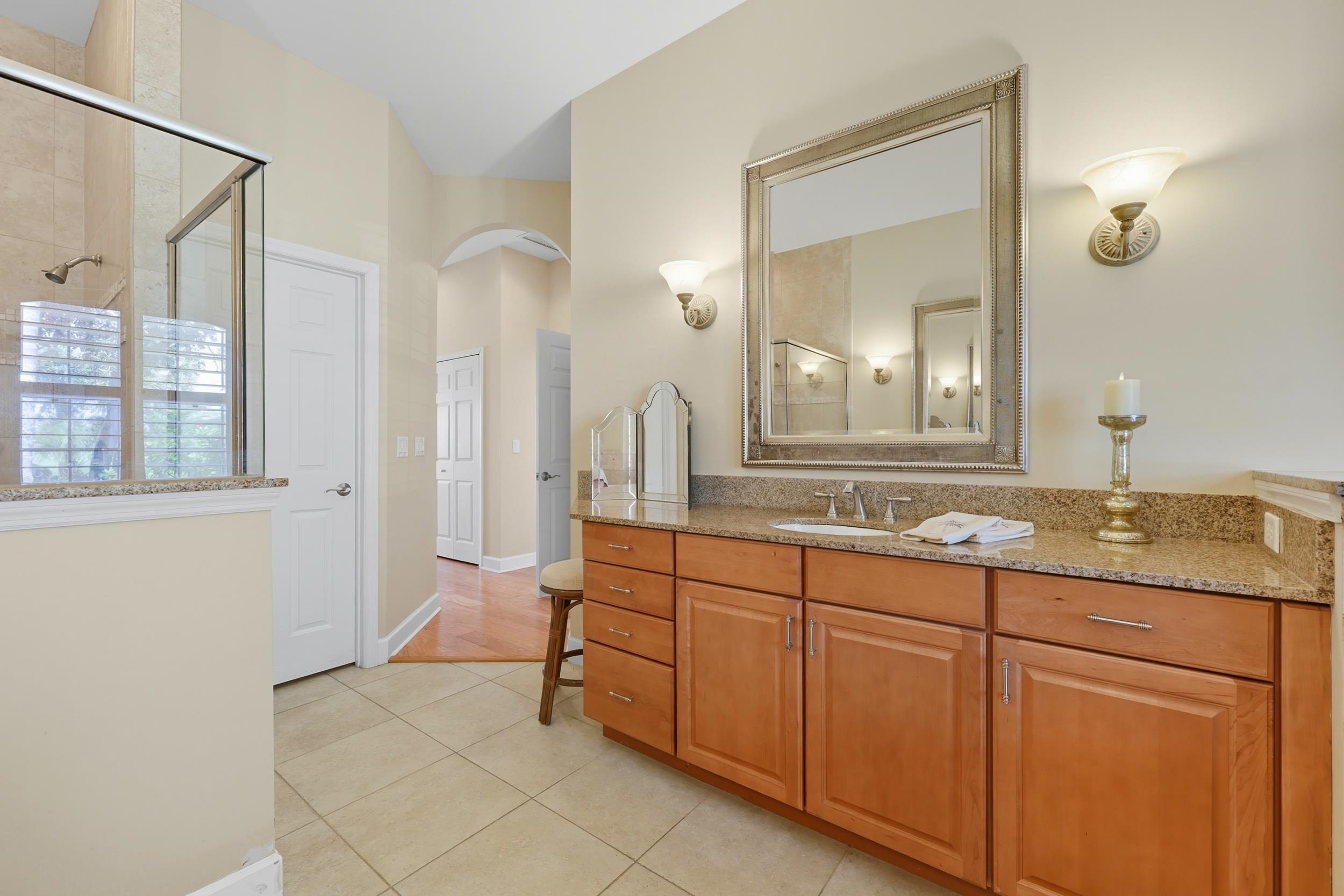 305 Marsh Point Circle St. Augustine, FL 32080 - Photo 27 of 82 a bathroom with a granite countertop sink and a mirror