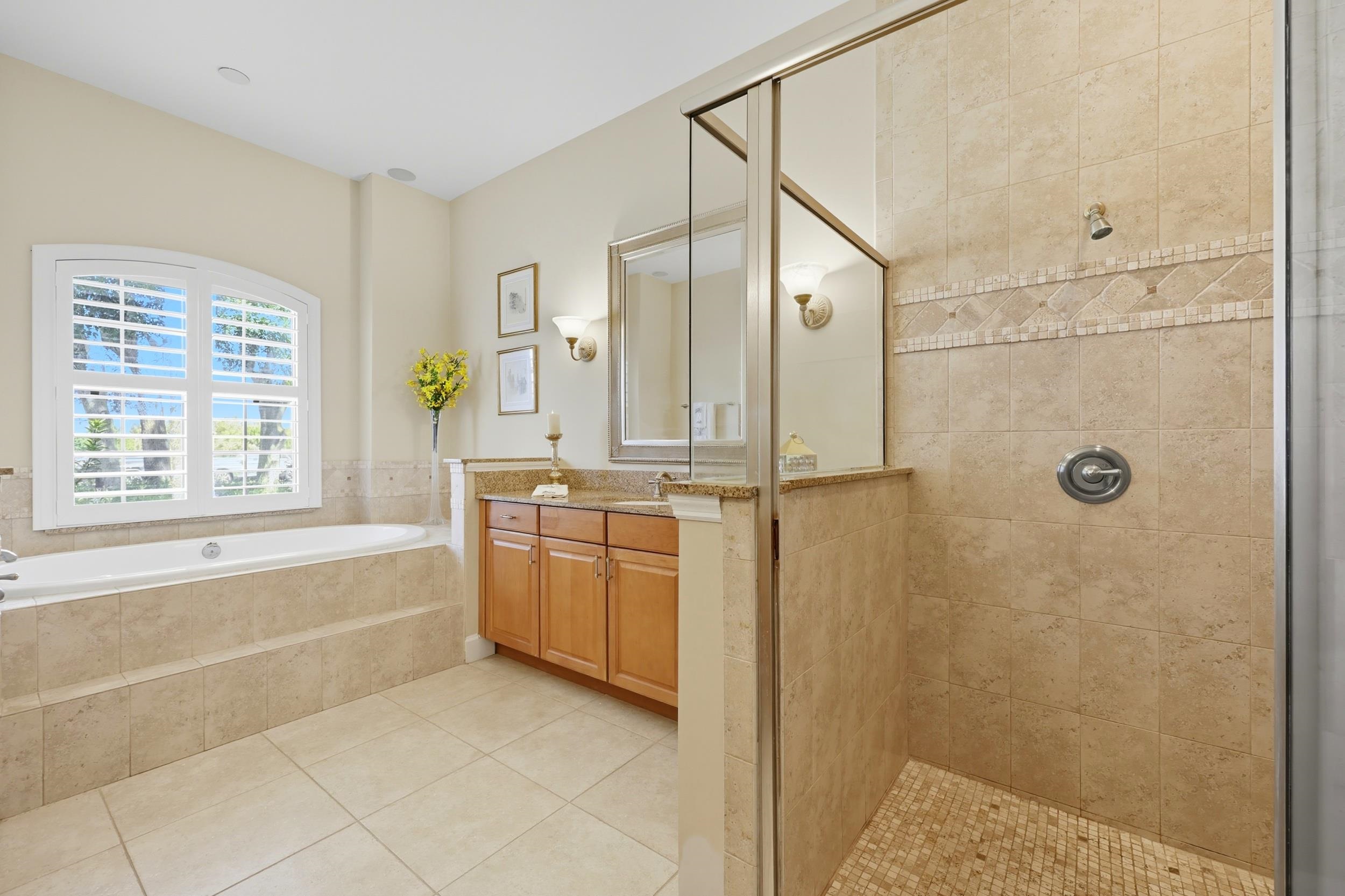305 Marsh Point Circle St. Augustine, FL 32080 - Photo 31 of 82 Full bathroom featuring a shower stall, vanity, a bath, and light tile patterned flooring