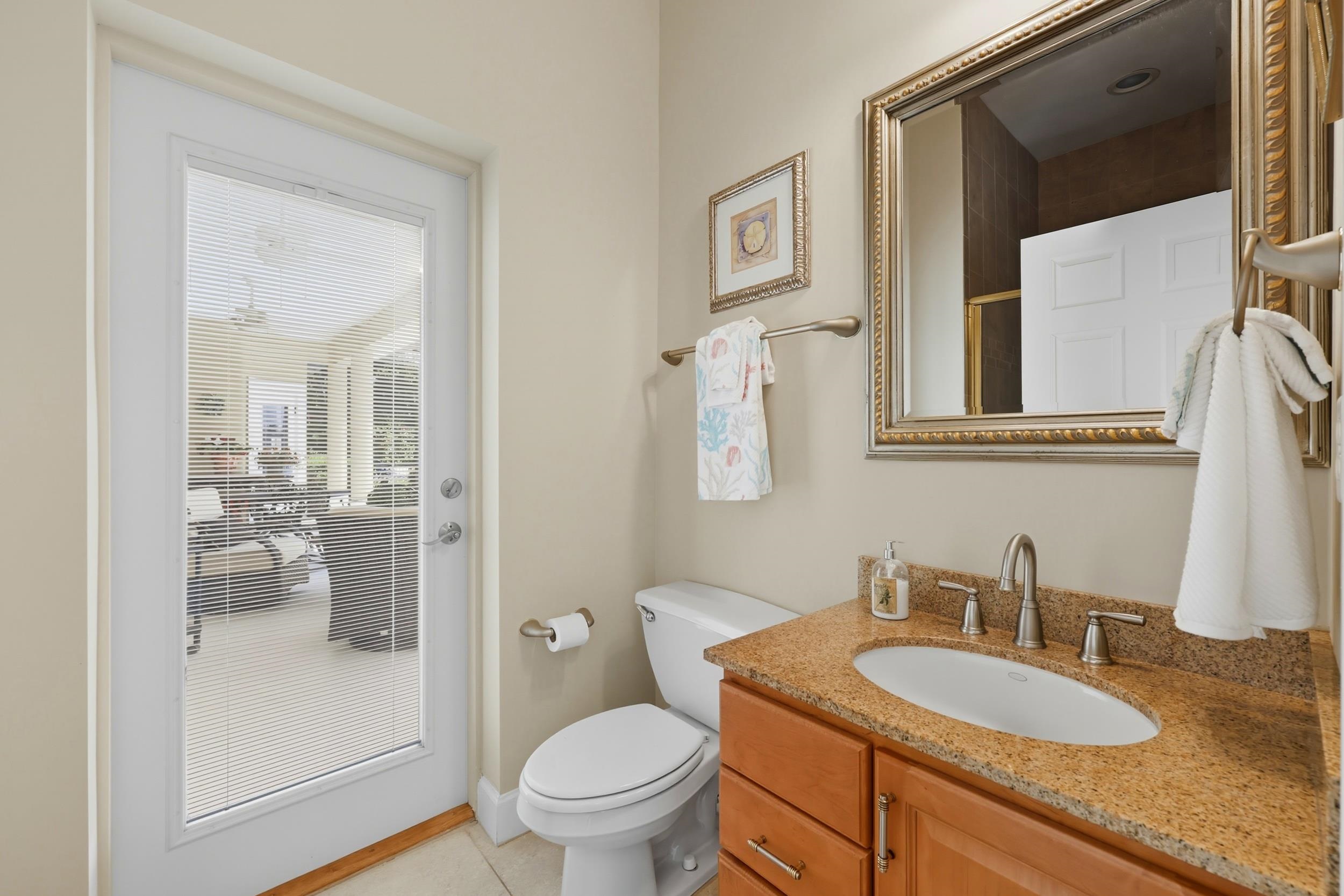 305 Marsh Point Circle St. Augustine, FL 32080 - Photo 34 of 82 a bathroom with a granite countertop sink toilet and shower