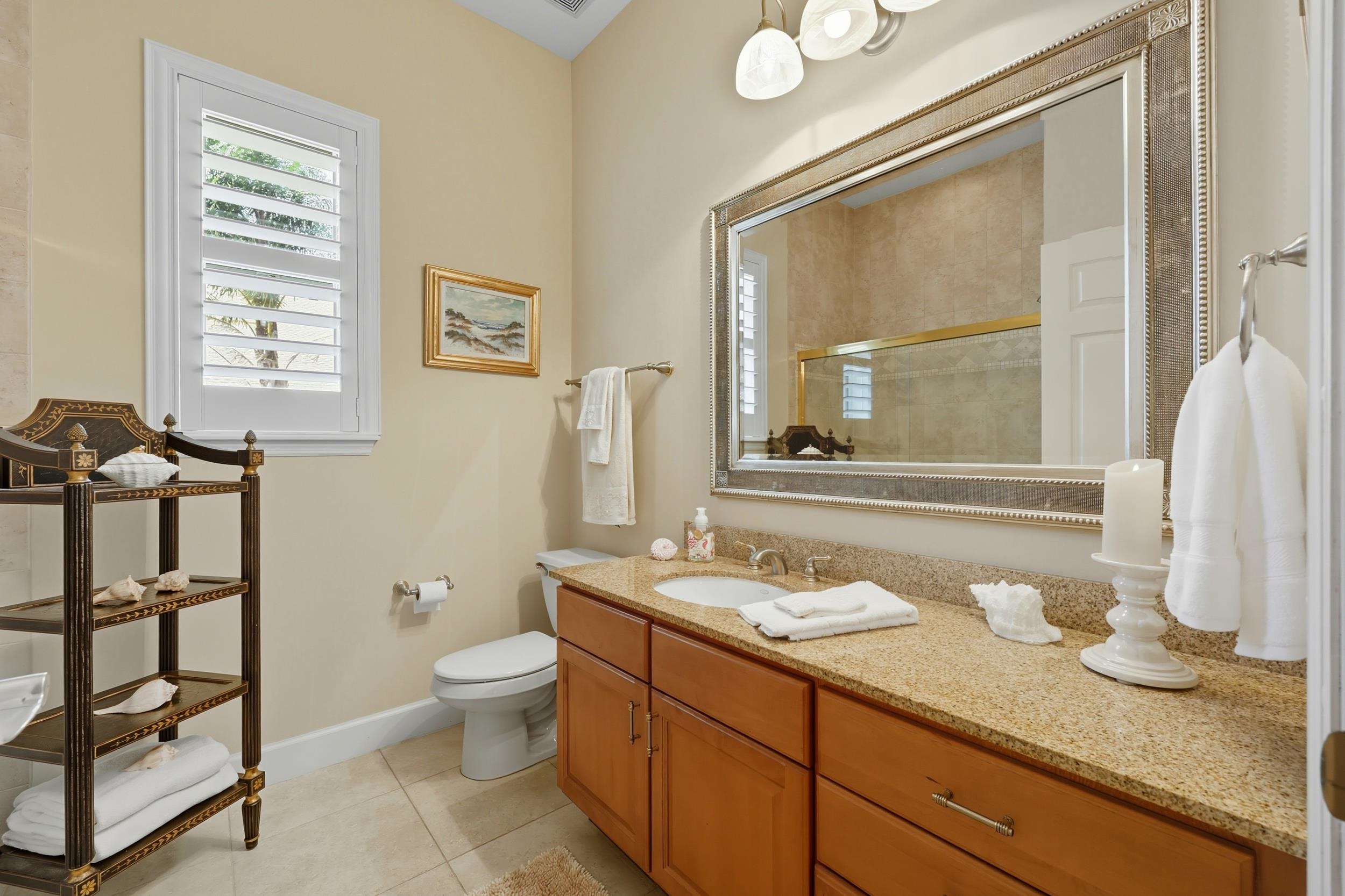 305 Marsh Point Circle St. Augustine, FL 32080 - Photo 37 of 82 a bathroom with a granite countertop sink toilet and a mirror